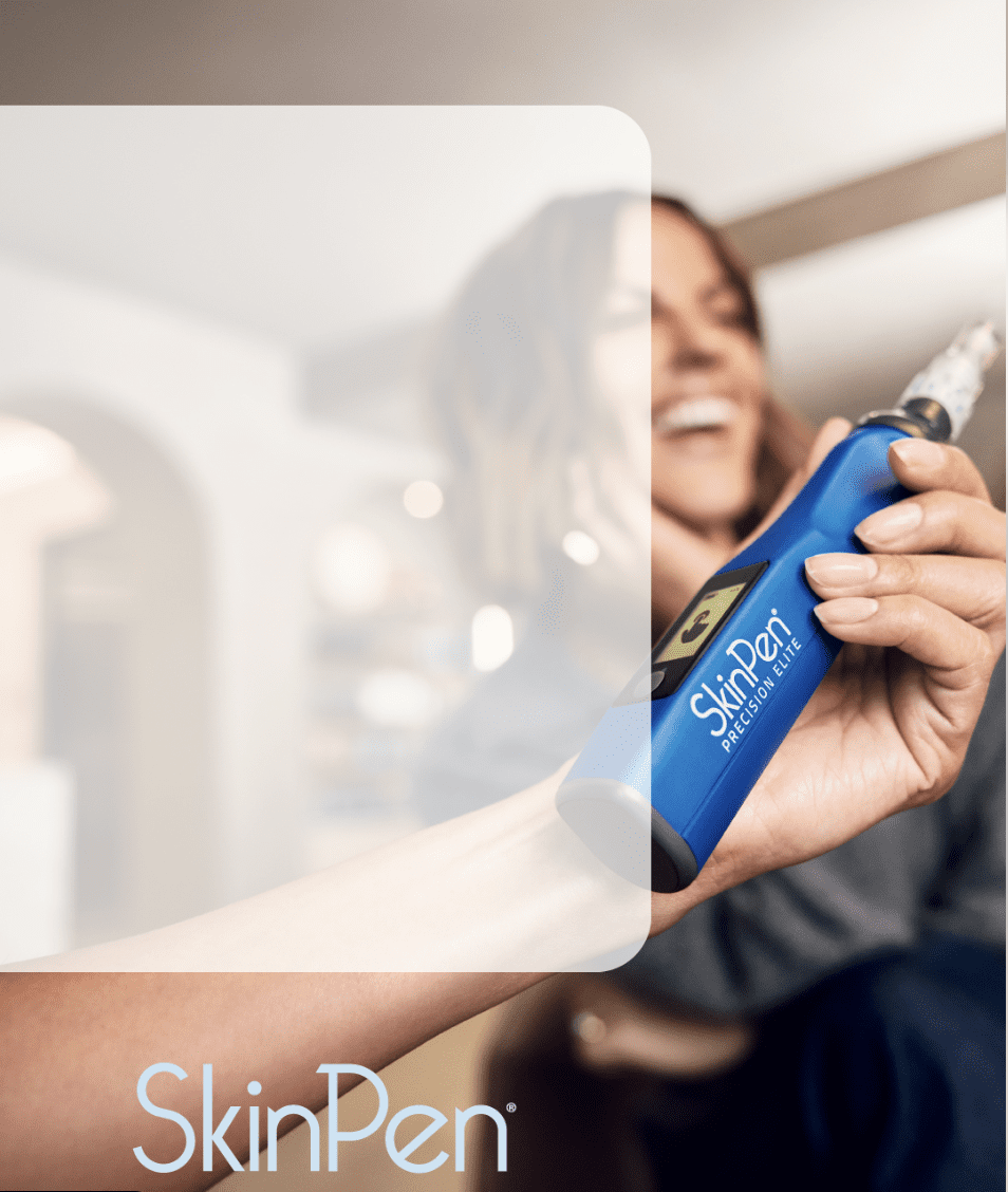 A woman holding a blue Colgate toothbrush with a blurred background.
