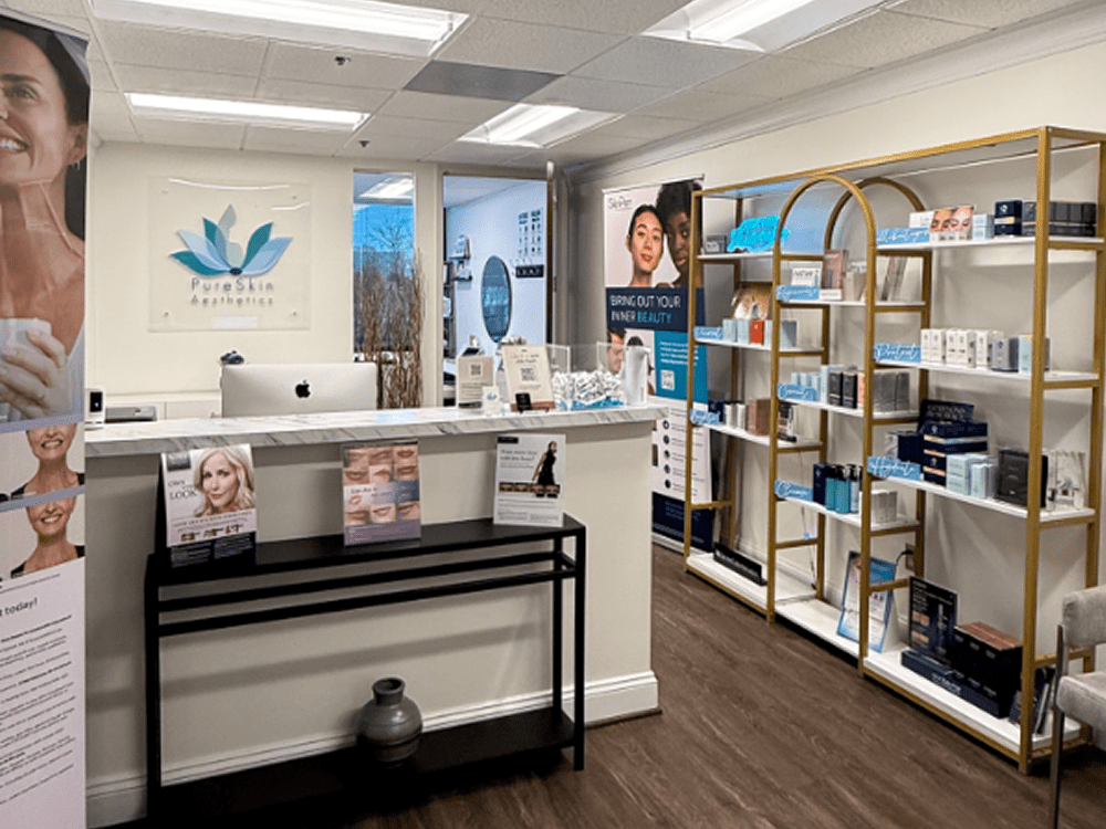 Modern skincare clinic reception with clean design and product display.