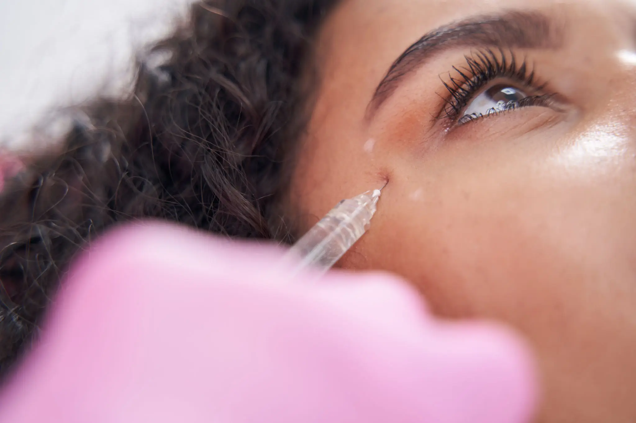 Close-up of a woman receiving an eye injection.