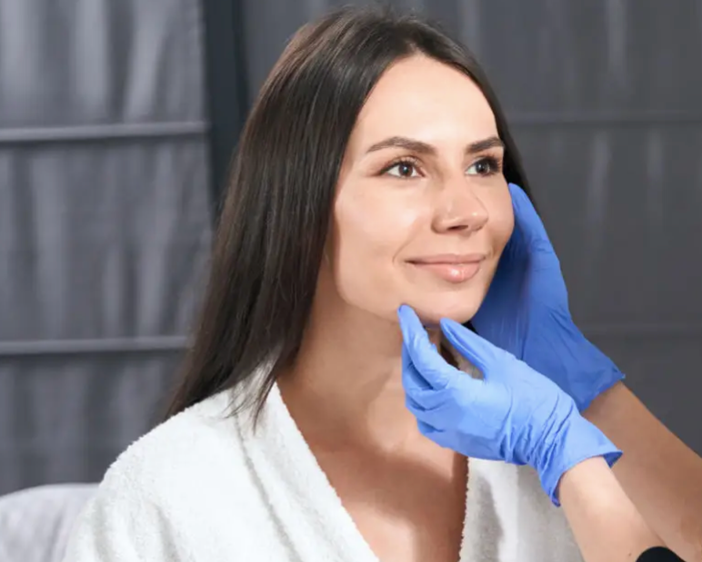 A woman receiving a facial examination from a medical professional.