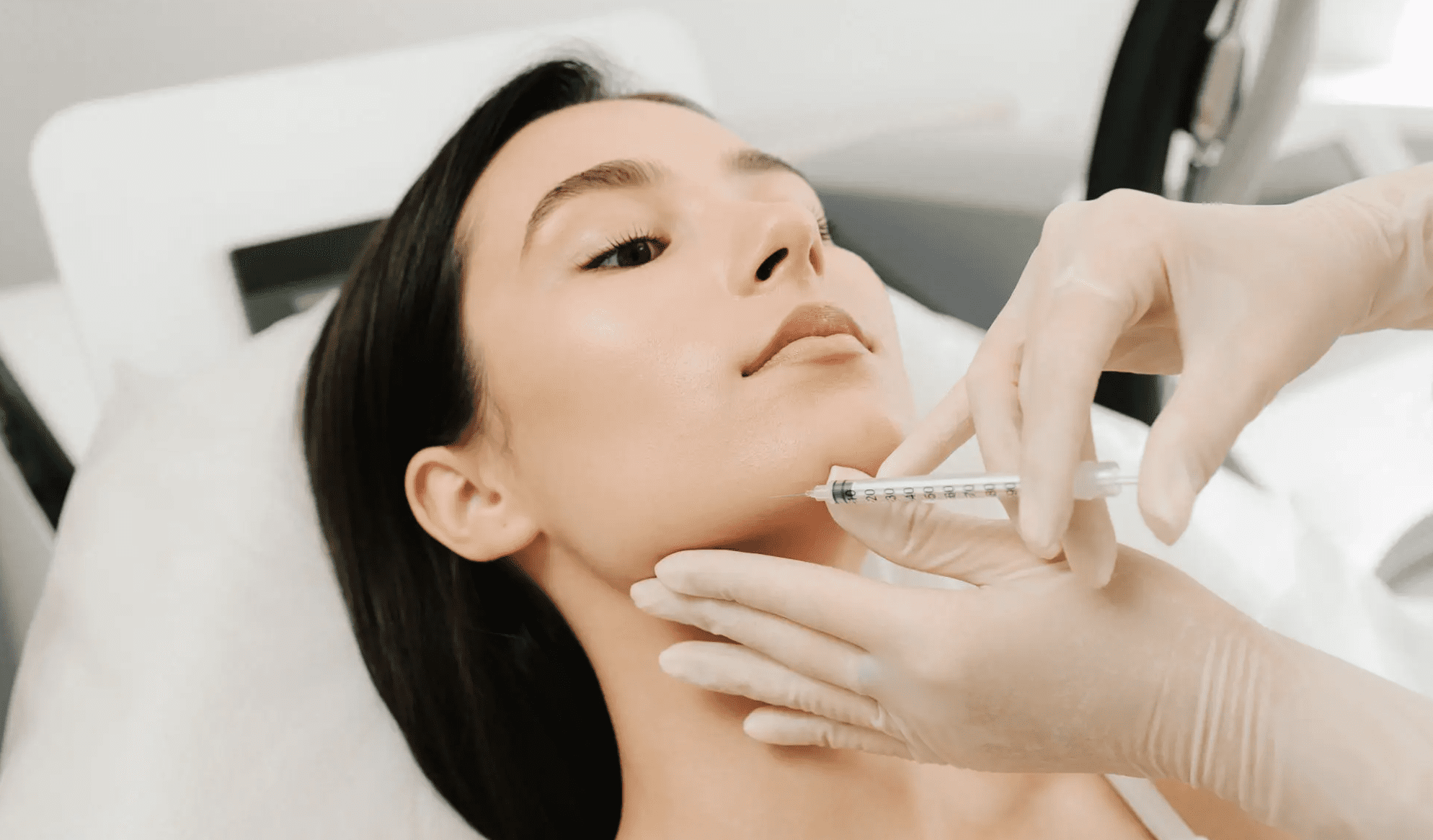 Woman receiving cosmetic jawline injection