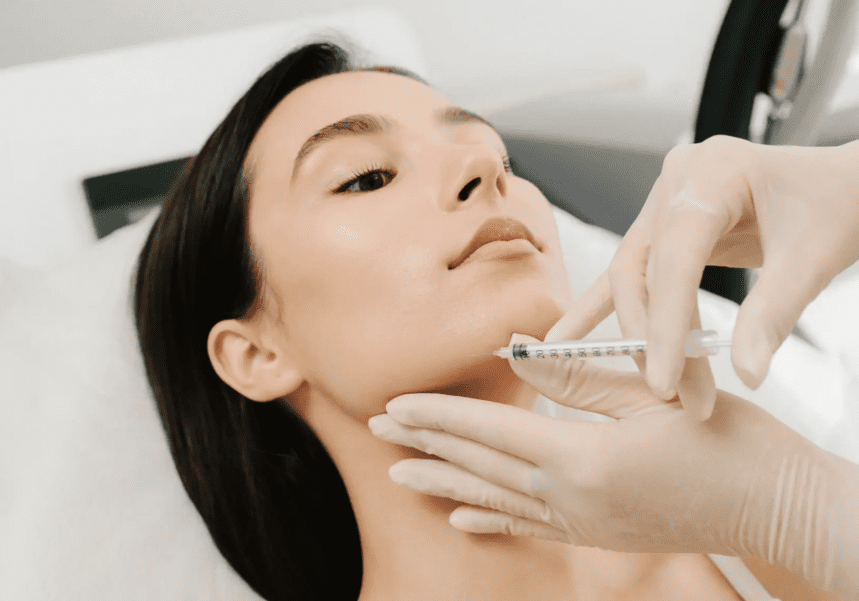 Woman receiving cosmetic jawline injection